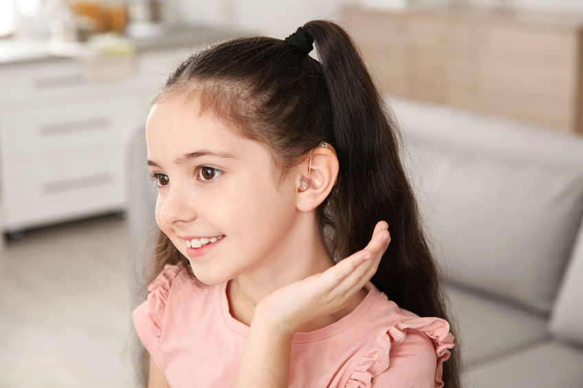 A girl with a hearing aid. 