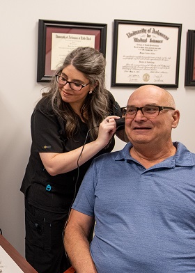 Dr. Meg performs real-ear measures on hearing aid fittings.