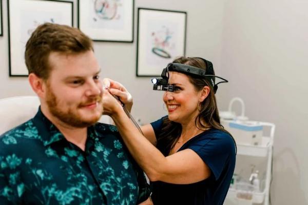 Dr cleaning pt's ear