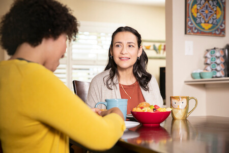 A woman struggles to hear a friend talking