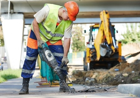 Construction worker using jackhammer