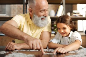 Grandfather doing a puzzle with child