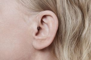 A woman wearing a hearing aid.