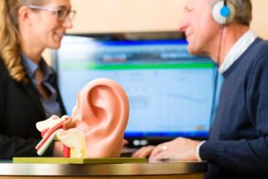 A man discusses hearing loss with his audiologist