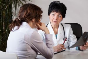 female physician going over test results with woman patient