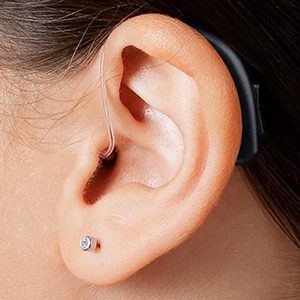 Image of a woman's ear with a hearing aid inside.
