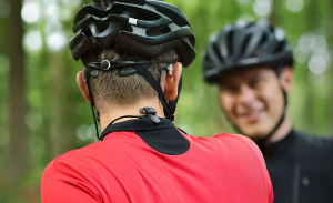 A cyclist wears an Oticon Safeline to secure his hearing aids in place.