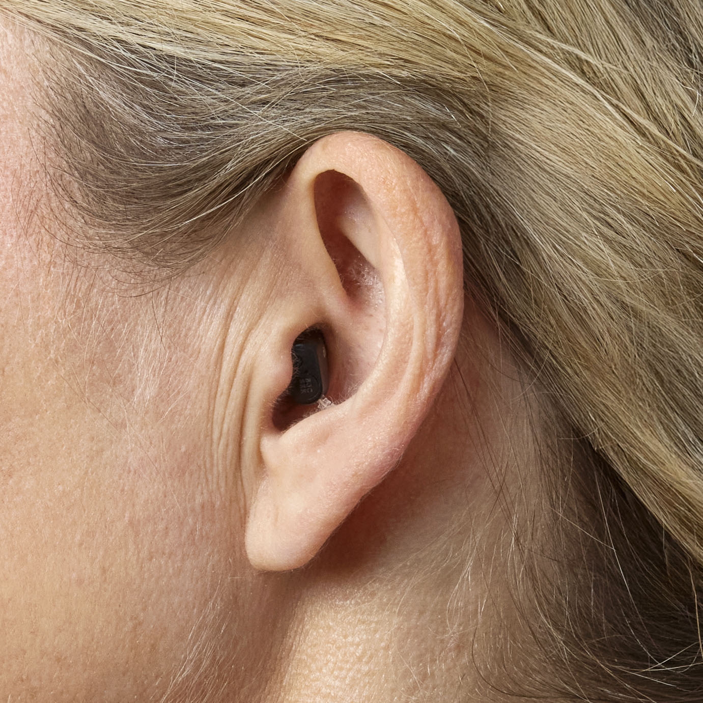 Woman wearing an Oticon Zeal hearing aid