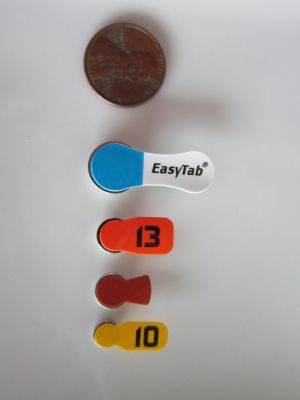4 sizes of hearing aid batteries compared to a penny