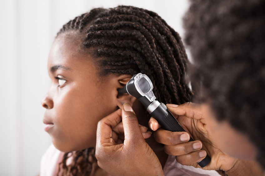 A child receives an ear exam.