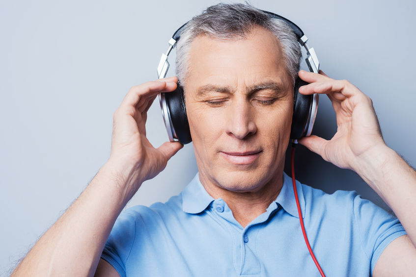 A man wearing headphones to help with sound sensitivity.