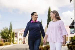 Two women walking outside.