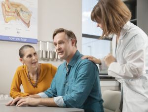 Person-centered hearing care, a man and wife at a hearing aid clinic appointment