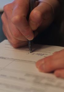 Person signing paperwork