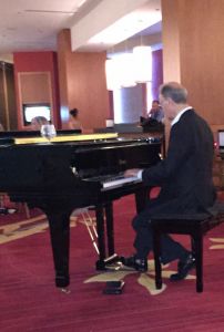 Pianist playing music in a hotel lobby