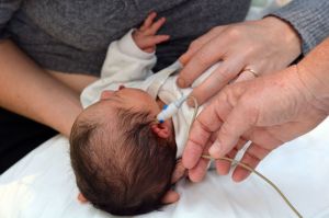 A newborn receives a hearing screening.