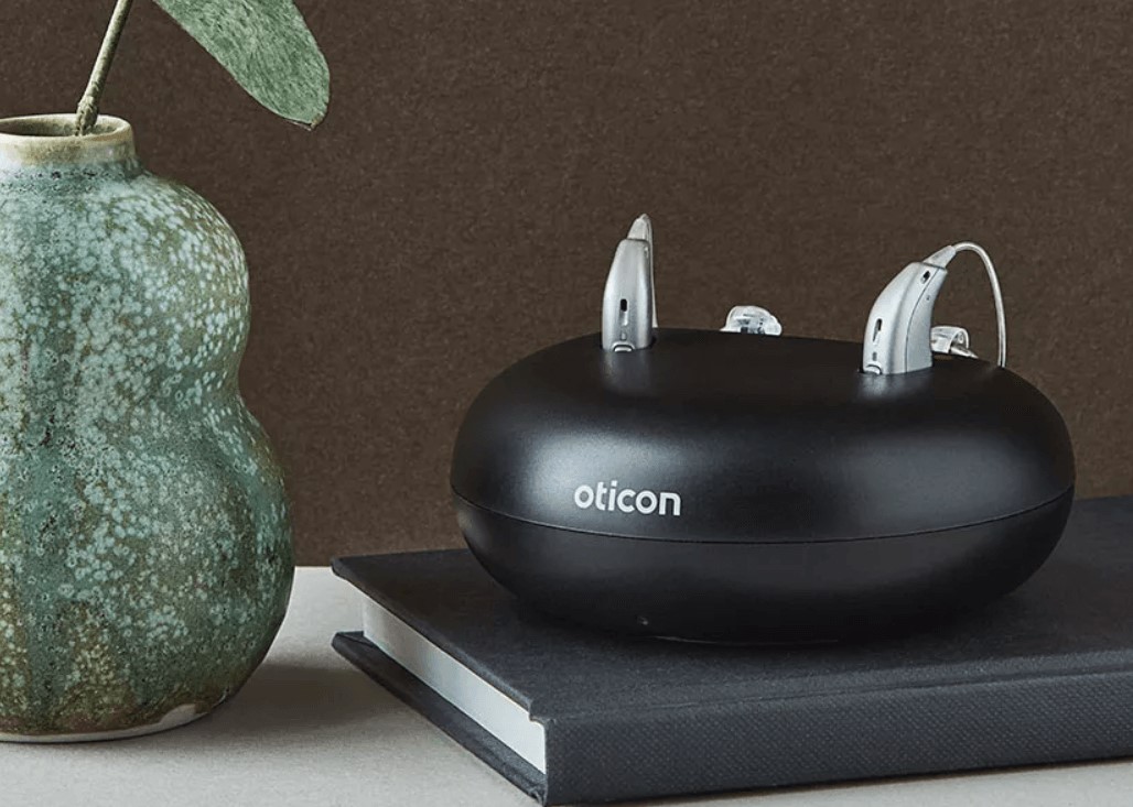 A pair of rechargeable Oticon More hearing aids. 