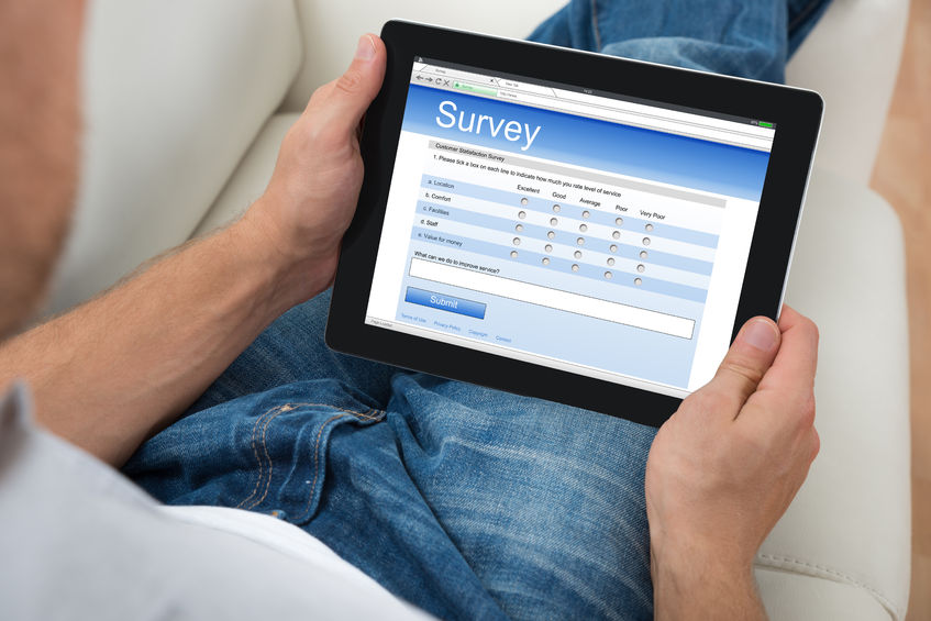 man taking online survey on tablet