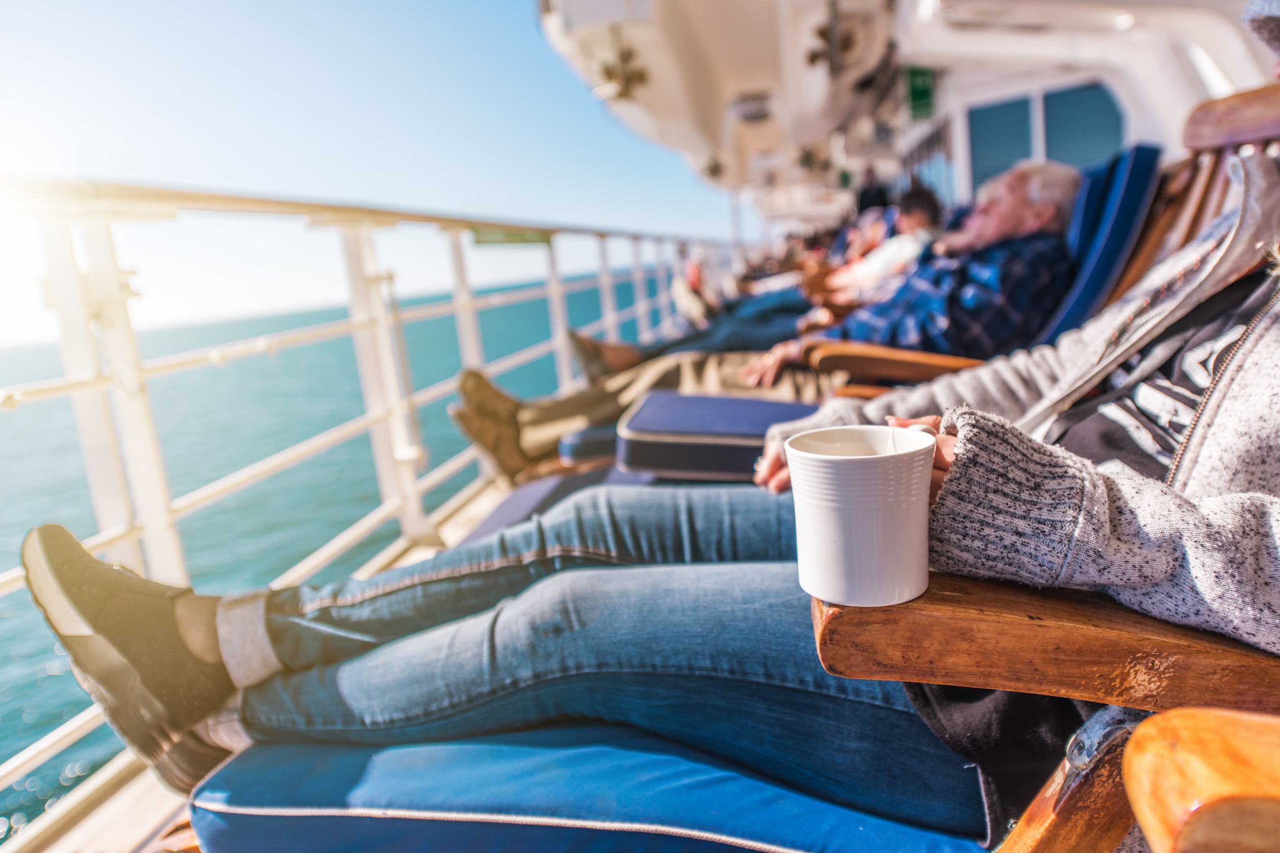 People relaxing on a cruise ship deck.